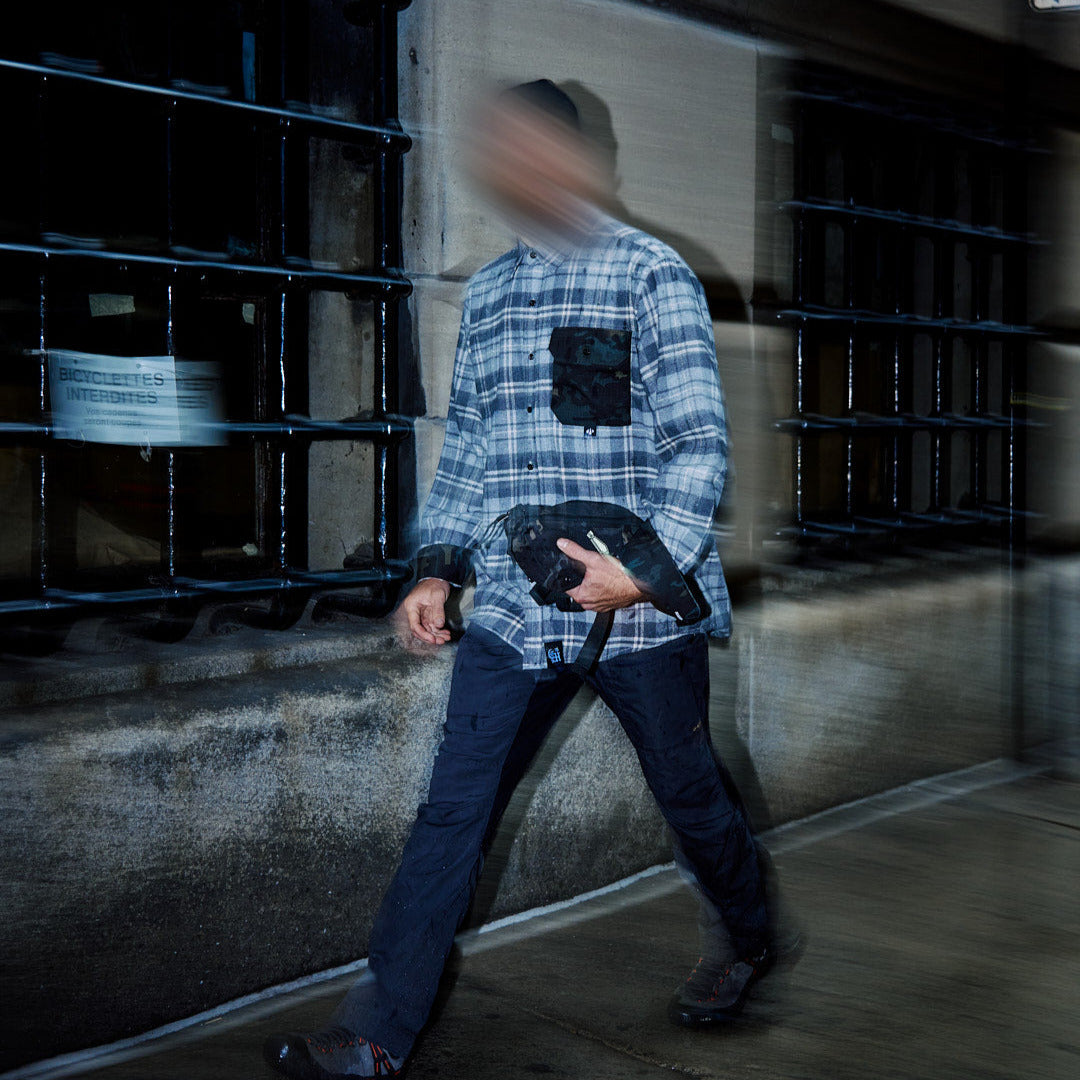 Person walking with a blurred face in an urban setting