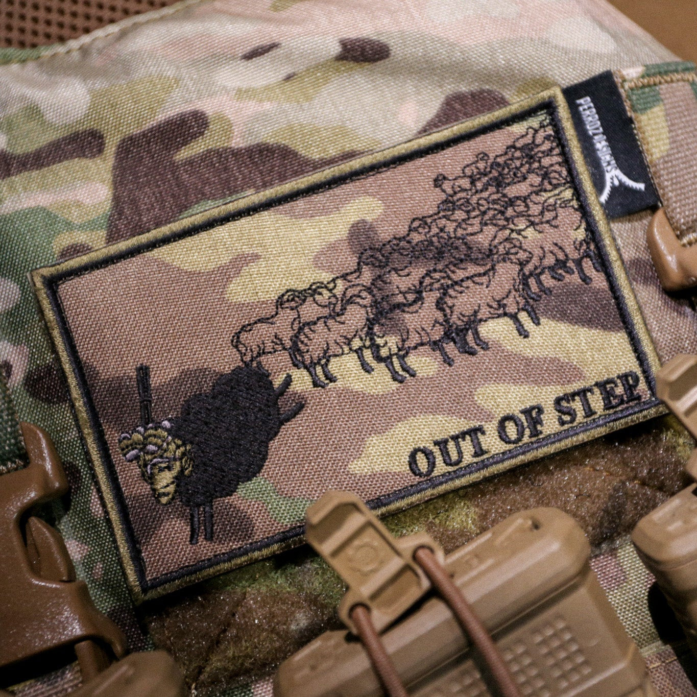 Camouflage patch with a bear design and 'Out of Step' text on a tactical background