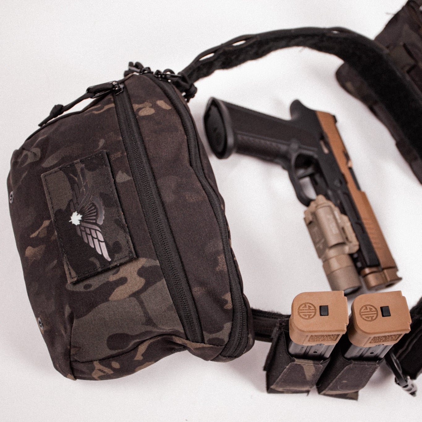 Camouflage tactical pouch with a gun and magazines on a white background