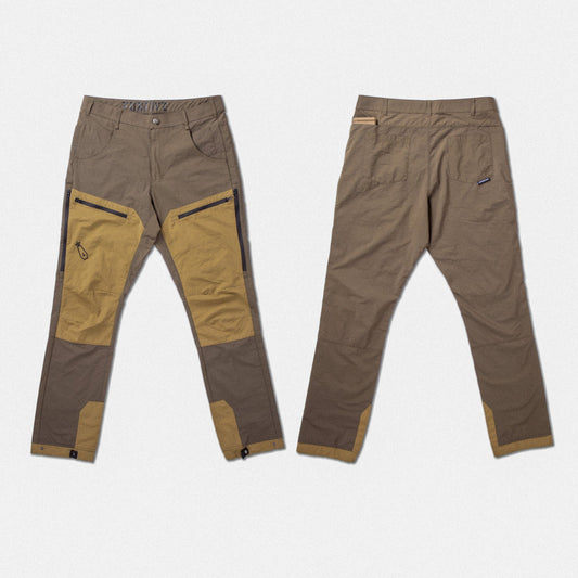 Two views of a pair of technical outdoor pants in brown and tan, showing the front with zippered knee panels and the back with a side pocket, on a light gray background.